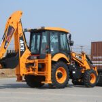 ACE AX 124 backhoe loader on a sunny day at Faridabad construction site.