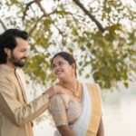 Beautiful Indian couple in traditional attire enjoying a romantic moment outdoors.