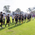 Group of soccer players entering the field at Deportes Bravos stadium, Texcoco, Mexico.