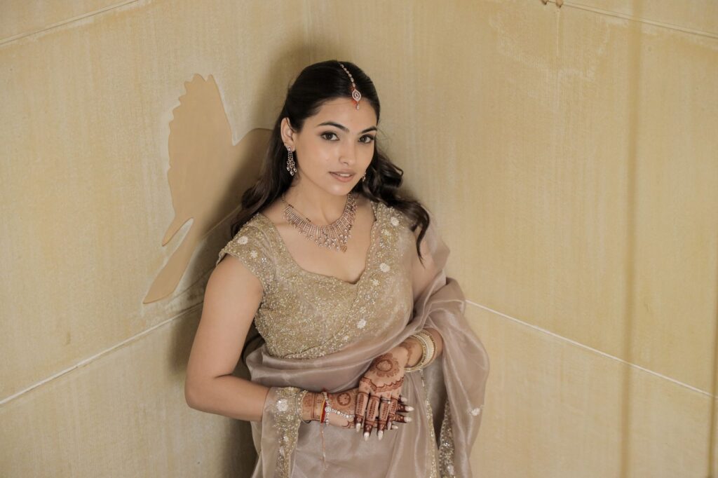 Beautiful South Asian bride in traditional attire with henna and gold jewelry.
