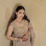 Beautiful South Asian bride in traditional attire with henna and gold jewelry.