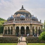 The majestic Isa Khan's Tomb stands amidst lush greenery in Delhi, showcasing Mughal architecture.