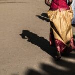 Traditional attire in Jaffna, Sri Lanka, casting artistic shadows on a sunny day.