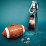 Football and trophy with championship rings on a celebratory background.