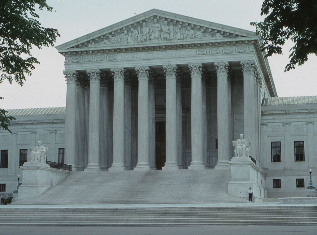 Front view of the iconic Supreme Court building with classical columns and majestic architecture.