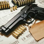 A handgun surrounded by bullets on vintage paper, featuring ammunition clips, conveying a sense of security.