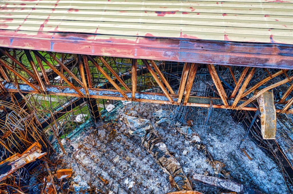 Aerial view of a rusty, abandoned industrial site in Banten, Indonesia showing decay and debris.