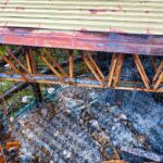 Aerial view of a rusty, abandoned industrial site in Banten, Indonesia showing decay and debris.