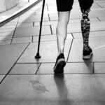 A person with a prosthetic leg walking confidently, symbolizing resilience and determination.