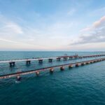 Aerial shot of the iconic Pamban Bridge over the blue waters of Rameswaram, India.
