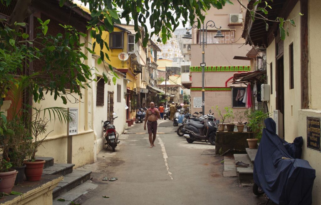 A quaint alley in Mumbai featuring local architecture and daily life.