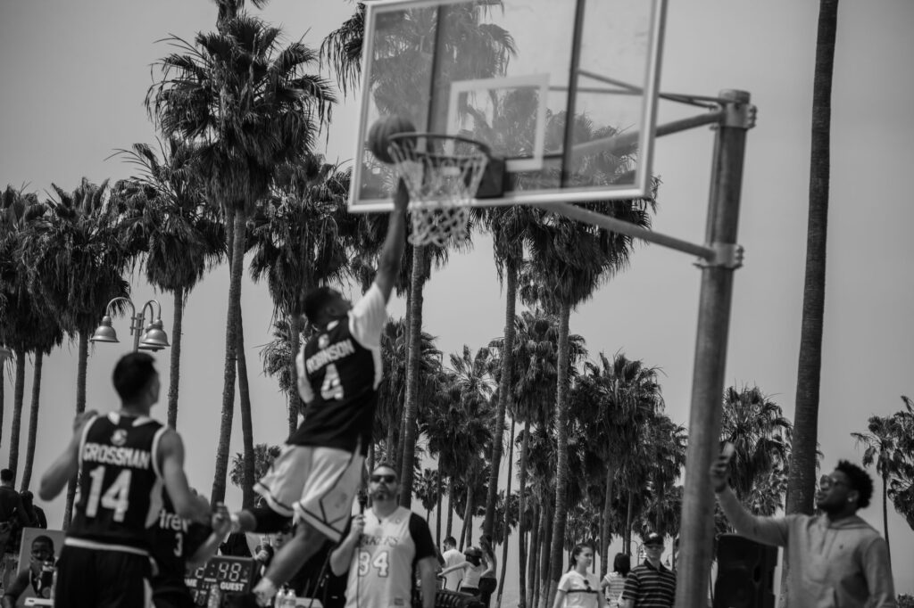 Dynamic black-and-white outdoor basketball game showcasing athleticism in Los Angeles.