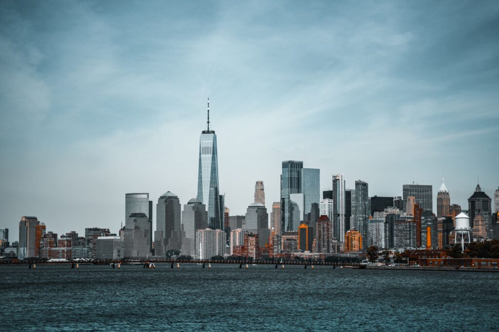 A stunning view of New York City's skyline featuring the One World Trade Center from the waterfront.