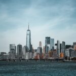 A stunning view of New York City's skyline featuring the One World Trade Center from the waterfront.