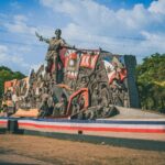 Historic Bonifacio Monument in Metro Manila against a vibrant blue sky.