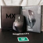 Modern black computer game mouse near box with text of description of functions