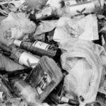 Monochrome photo showcasing littered bottles and trash highlighting pollution.