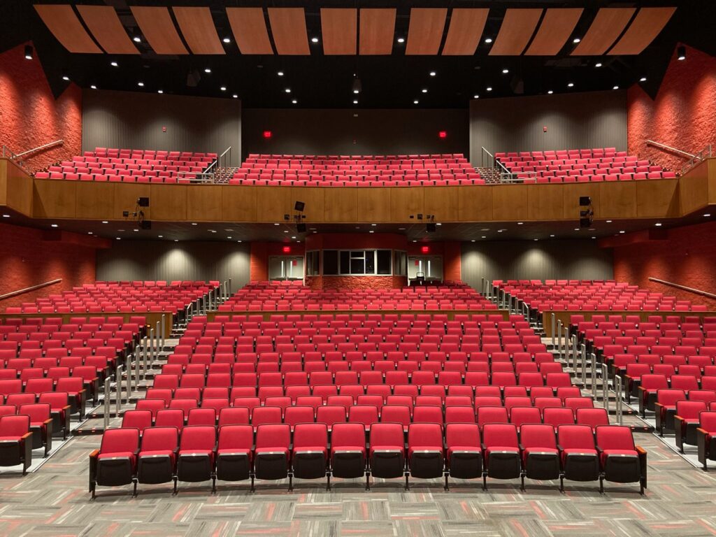 Red seat auditorium in Trenton, NJ with contemporary lighting and design.