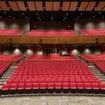 Red seat auditorium in Trenton, NJ with contemporary lighting and design.