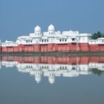 Stunning view of Neermahal Palace reflected in the serene waters of the lake in Agartala, India.