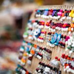 Vibrant handmade jewelry on display at a lively Indian market.