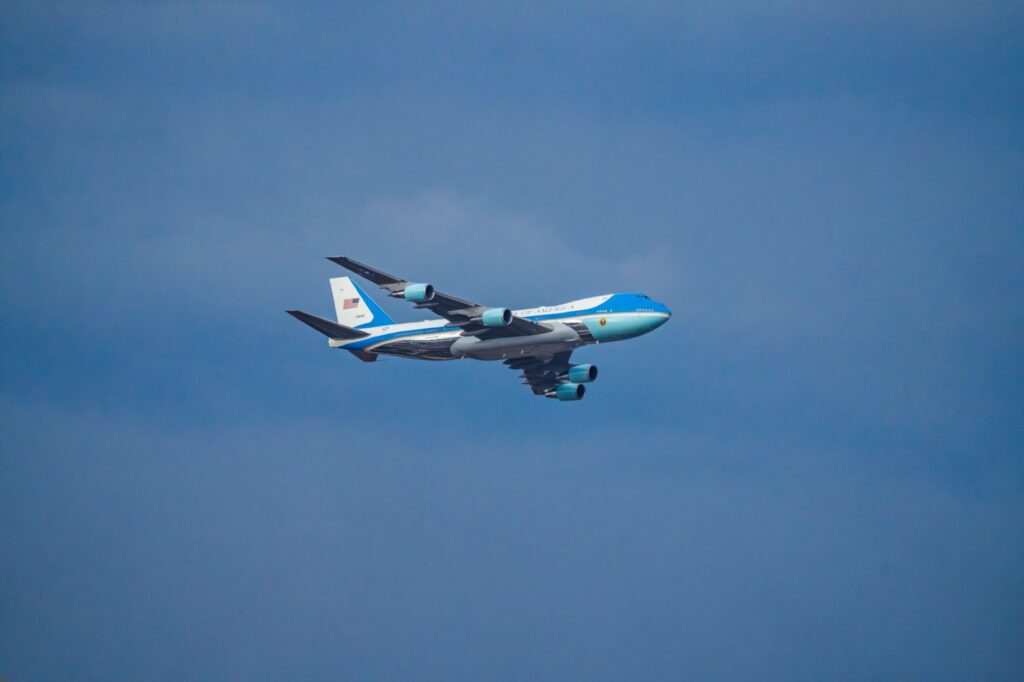 Air Force One airplane flying in the clear blue sky over Washington, DC.