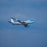 Air Force One airplane flying in the clear blue sky over Washington, DC.