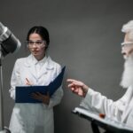 Scientists in lab coats analyze advanced robotics technology, highlighting innovation and teamwork.