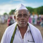 A close-up of a pilgrim at a vibrant religious gathering in Pandharpur.