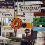 Colorful mix of multilingual signs in a busy Asian street, showcasing diverse cuisines and cultures.