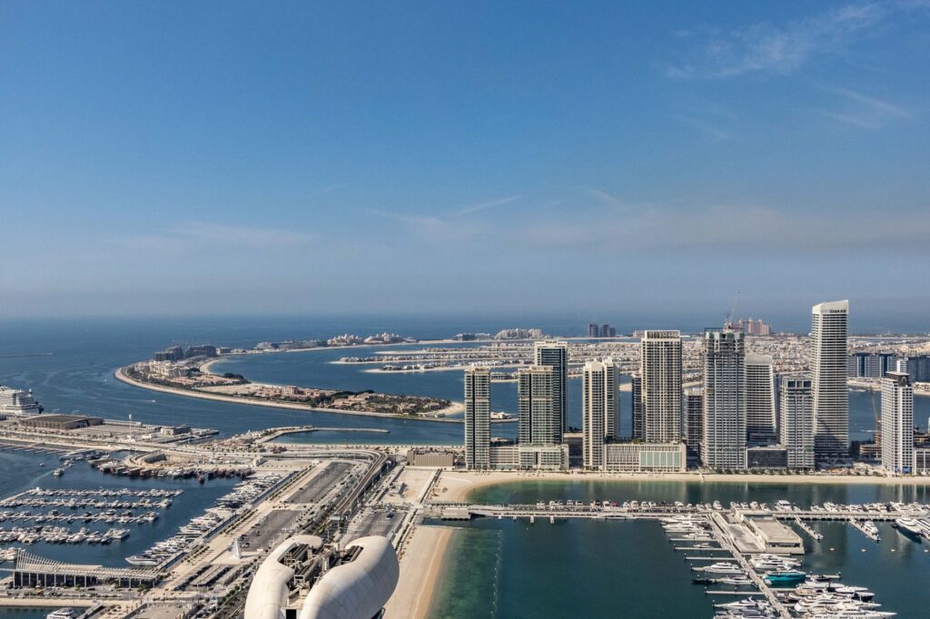 A breathtaking aerial view of Dubai Marina and Palm Jumeirah with modern skyscrapers and clear blue waters.