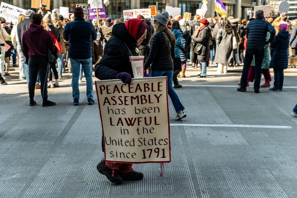A demonstration advocating peaceable assembly rights in a city street.