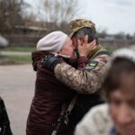 Heartfelt embrace in Makariv, Ukraine, capturing the emotional reunion.