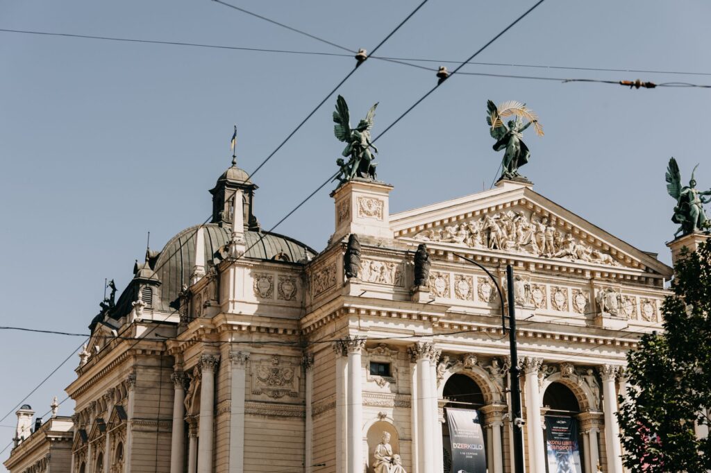 Lviv Theatre of Opera and Ballet under a sunny blue sky, showcasing intricate architecture.