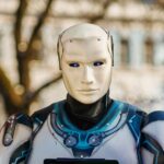 Close-up of a humanoid robot with a futuristic design posing outdoors.