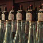 Rows of vintage whisky bottles create a warm, classic atmosphere in a Tokyo bar.