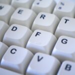 Detailed view of a white computer keyboard focusing on keys. Perfect for technology themes.