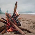 A cozy bonfire on a picturesque beach, perfect for a tranquil evening.