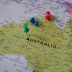 Close-up of a map of Australia featuring colorful pushpins marking locations.