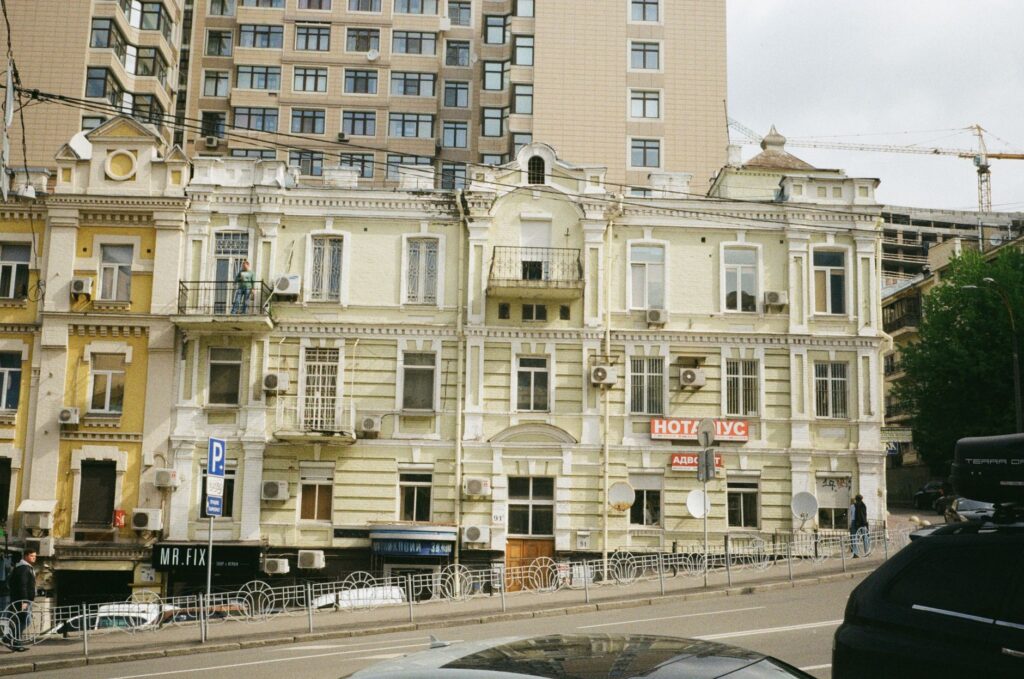 Street view of historic and modern buildings in Kyiv, Ukraine showcasing diverse architectural styles.