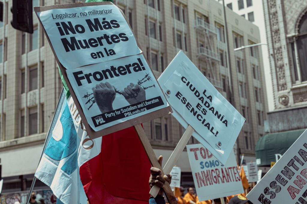Protesters in Los Angeles rally for immigration rights with powerful messages on signs.