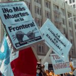 Protesters in Los Angeles rally for immigration rights with powerful messages on signs.