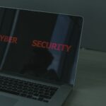 Close-up of a laptop displaying cybersecurity text, emphasizing digital security themes.