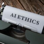 Retro typewriter with 'AI Ethics' on paper, conveying technology themes.