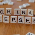 Close-up of wooden Scrabble tiles spelling 'China' and 'Deepseek' on a wooden surface.