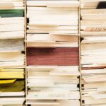 Close-up view of stacked documents in various colors organized in a file system.