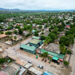 A vibrant aerial view of a city in Africa with lush greenery and urban structures.