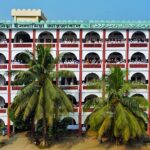 Aerial shot of an Islamic school building surrounded by palm trees in Dhaka, Bangladesh.