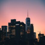 Captivating sunset over Manhattan skyline featuring One World Trade Center in clear view.