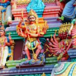 Vibrant statues depicting Hindu deities on a temple facade in Chennai, showcasing rich cultural art.